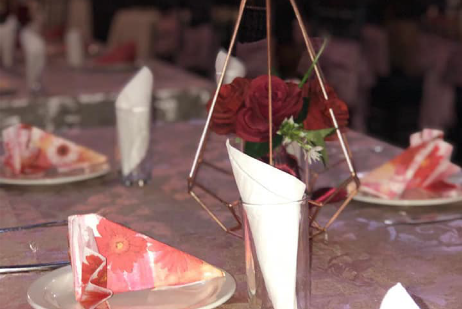 Floral centrepiece and folded napkins for a celebration